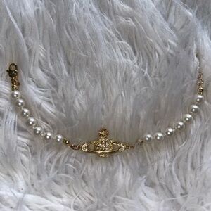 Vivienne Westwood gold and silver bracelet still in the bag and box